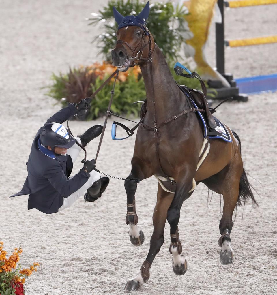 Alberto Michan from Israel is thrown from his horse Cosa Nostra after the horse refused to jump the water hazard