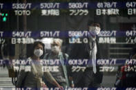 People are reflected on a blank electronic stock board supposedly showing Japan's Nikkei 225 index at a securities firm Thursday, Oct. 1, 2020, in Tokyo. Trading on the Tokyo Stock Exchange was suspended Thursday because of a problem in the system for relaying market information. Most other Asian markets were closed for national holidays. (AP Photo/Eugene Hoshiko)