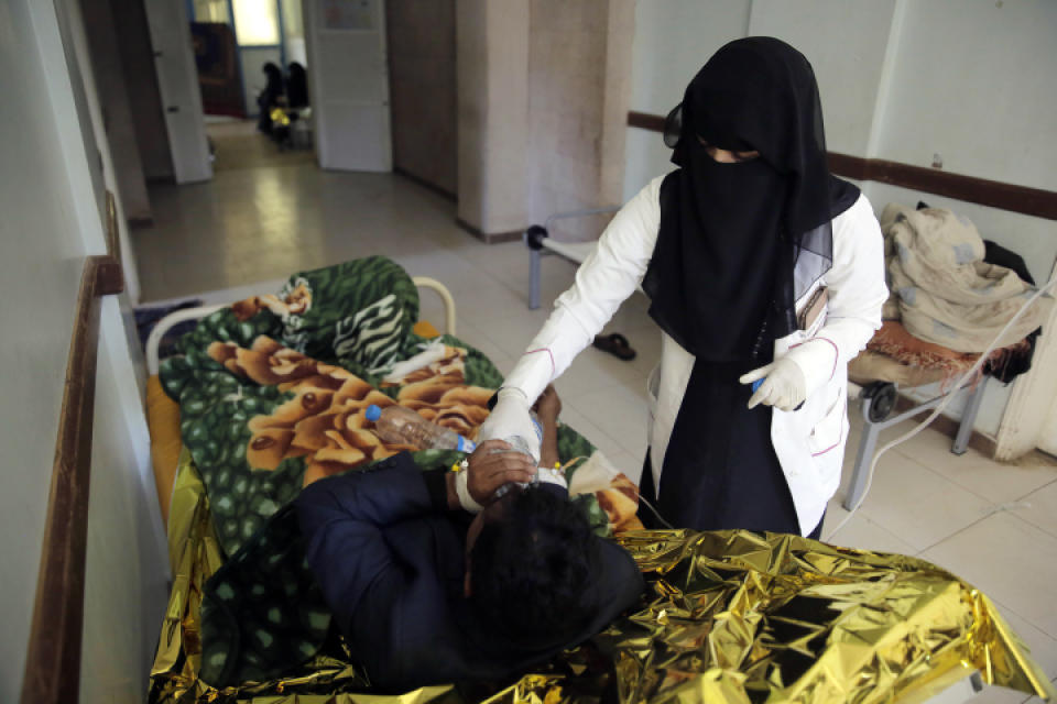 FILE - In this Thursday, March 28, 2019 file photo, a man is treated for suspected cholera infection at a hospital in Sanaa, Yemen. Cholera is surging once more in Yemen, with more than 76,000 suspected new cases and 195 deaths in March, double the number in the previous two months, according to U.N. figures. Doctors point to the difficulty in controlling epidemics in a country where infrastructure has been decimated by four years of war. (AP Photo/Hani Mohammed, File)