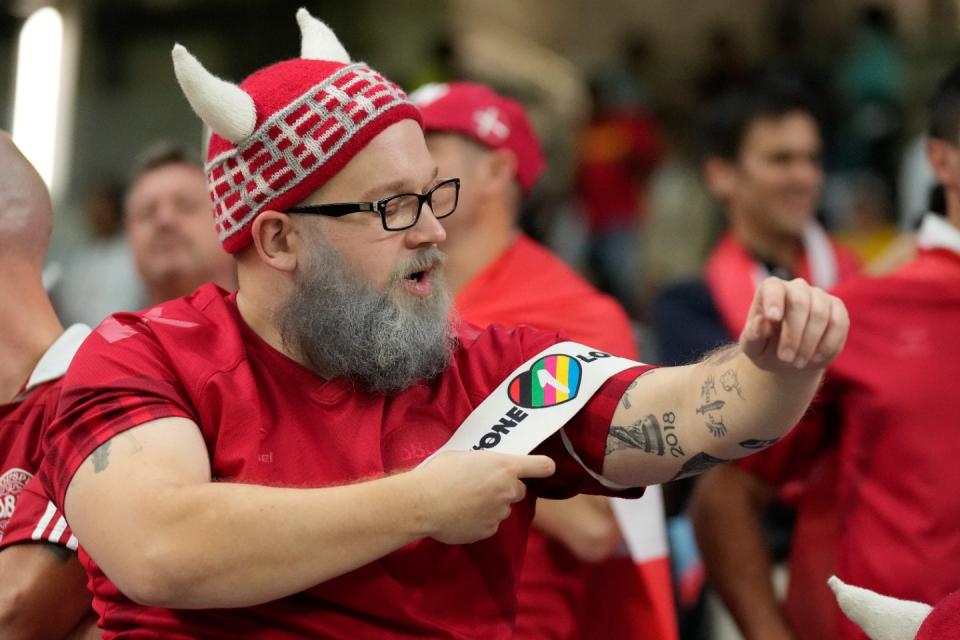 A Danish fan puts 'one love' banner on his arm before the World Cup group D football match between Australia and Denmark, at the Al Janoub Stadium in Al Wakrah, Qatar, Wednesday, Nov. 30, 2022. (AP Photo/Aijaz Rahi)