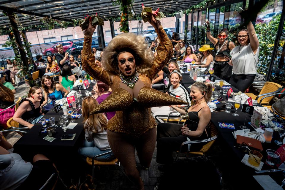 Ophelia Hotass collects tips May 6, 2023, as she lip-syncs during a Madonna-and-Whitney-Houston-themed drag queen brunch at the Craftsman in Fair Lawn.