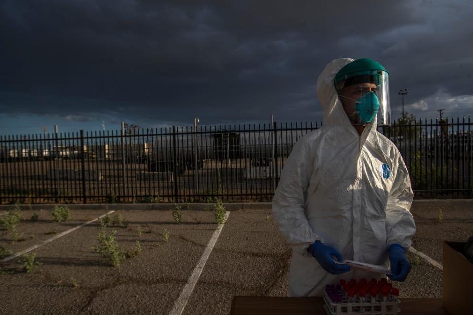 Cristian Franco, lead medical assistant of Vo Medical Group in Calexico, performs testing with patients wanting to know if they are COVID-19 positive on April 7, 2020.