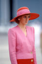 <p>Shoulder pads, a wide-brimmed hat and a blend of hot pink and rose pink make this outfit one of our favourite Princess Diana looks of all time. <i>[Photo: Rex]</i></p>