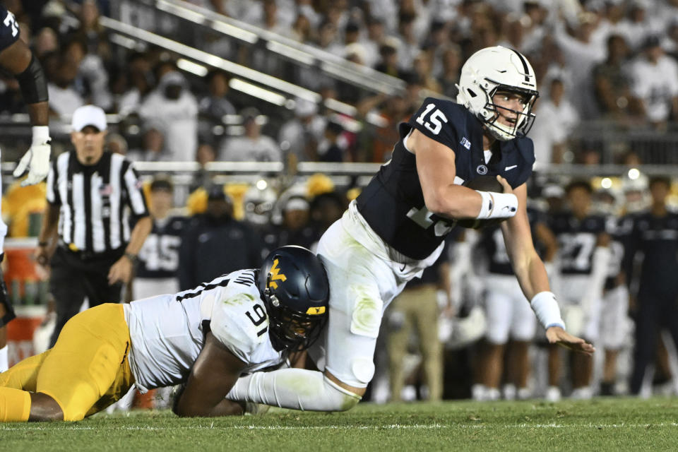 West Virginia defensive lineman Sean Martin (91) tackles Penn State quarterback Drew Allar (15) during the first half of an NCAA college football game Saturday, Sept. 2, 2023, in State College, Pa. (AP Photo/Barry Reeger)