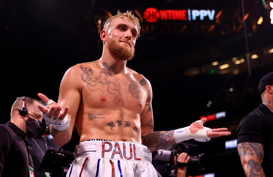 Seen here, Jake Paul reacts to knocking out Tyron Woodley during a fight on December 18, 2021.