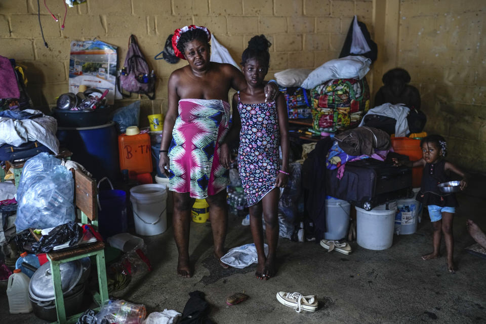 Baby Gustave, left, and her 12-year-old daughter Juliana St. Vil pose for a photo at a school converted into a shelter where they now live after fleeing gang violence in their neighborhood, in Port-au-Prince, Haiti, Saturday, May 18, 2024. (AP Photo/Ramon Espinosa)