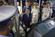 Japan's Prime Minister Fumio Kishida, center, sits on the bridge of the BRP Teresa Magbanua ship at the Philippine Coast Guard headquarters on Saturday Nov. 4, 2023 in Manila, Philippines. (Ezra Acayan/Pool Photo via AP)