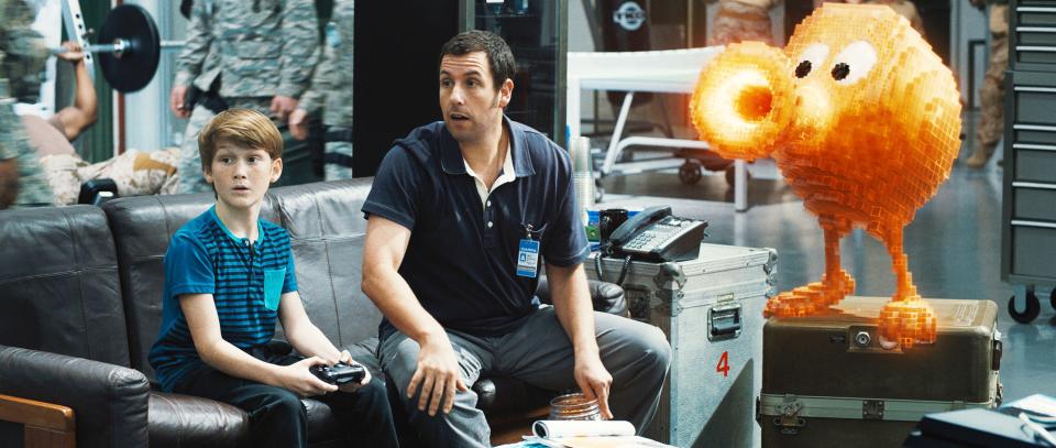 PIXELS, from left: Matt Lintz, Adam Sandler, Qbert, 2015. ©Columbia Pictures/courtesy Everett Collection