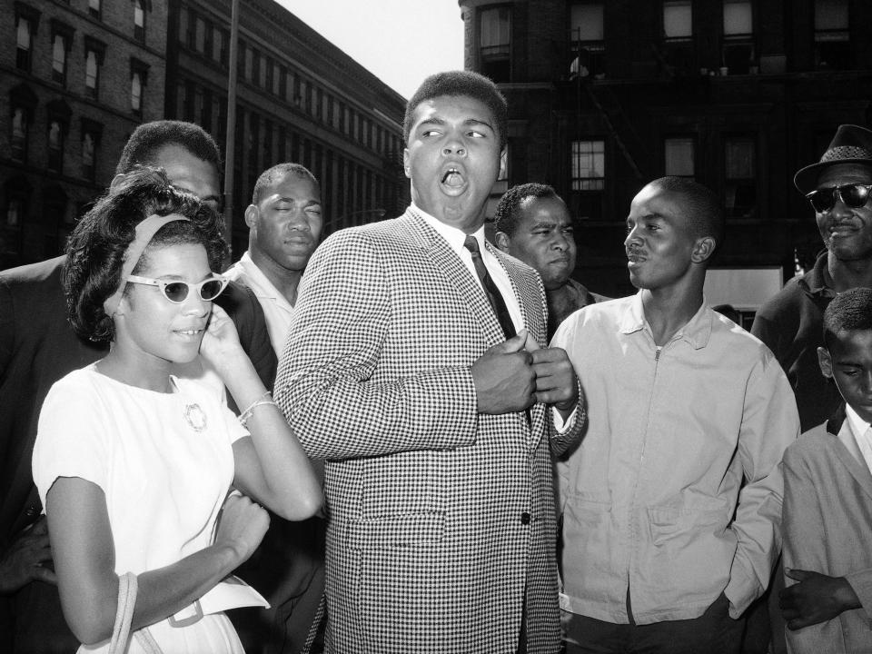 Boxer Cassius Clay draws a mixed audience reaction at a rally in upper Manhattan, New York, Aug. 10, 1963, as he gives black Muslim leader Malcolm X a little verbal competition.