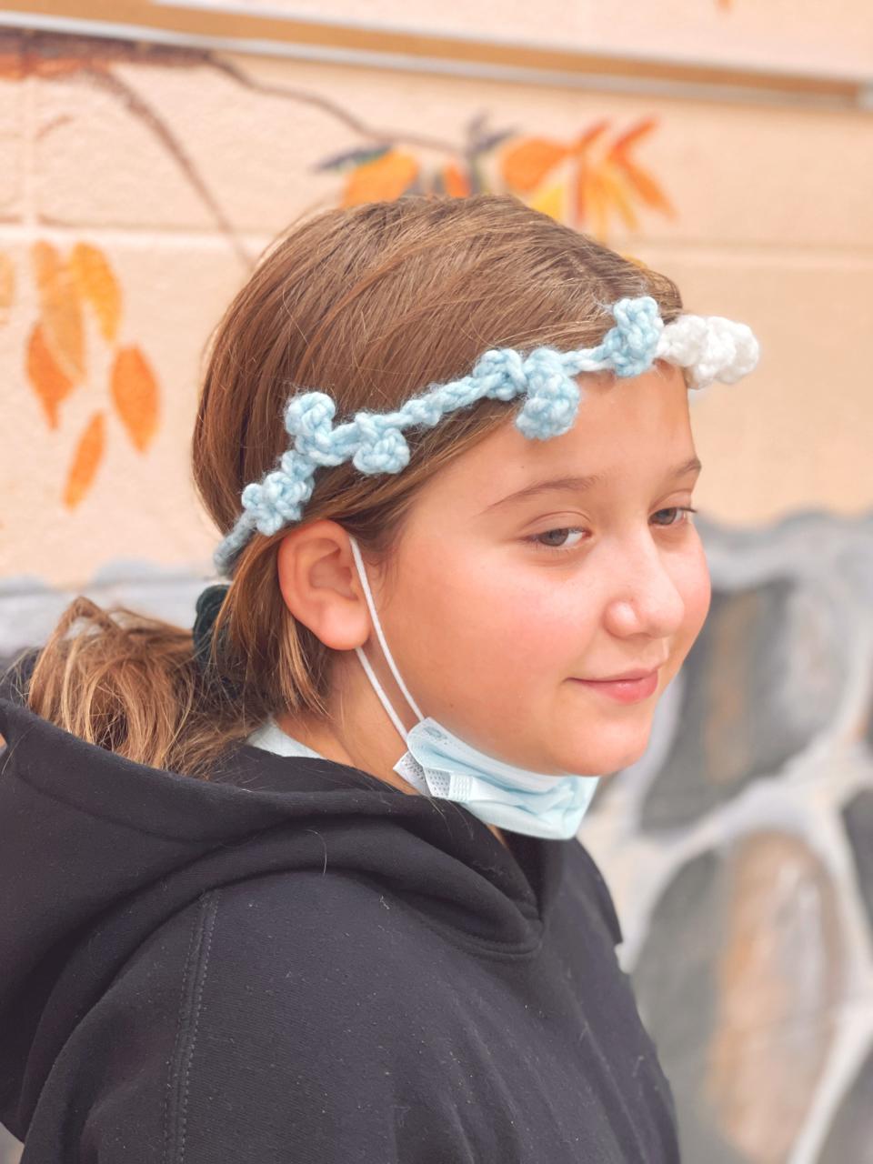 Mya Silva, a fourth grader at Dogwood Elementary School, taught herself to crochet using a pencil and has made several headbands for friends and teachers. Nov. 18, 2021. “It supports the back of your head a bit,” said Silva. “Ellery said it is like a crown.”