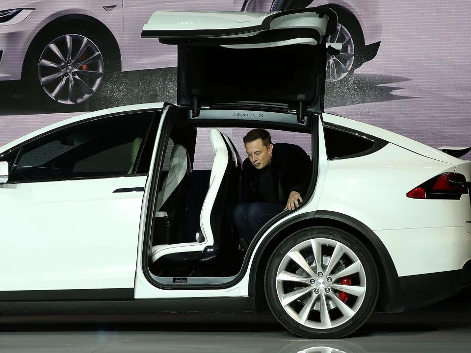 Tesla CEO Elon Musk steps out of the new Tesla Model X during an event to launch the company's new crossover SUV on September 29, 2015 in Fremont, California.