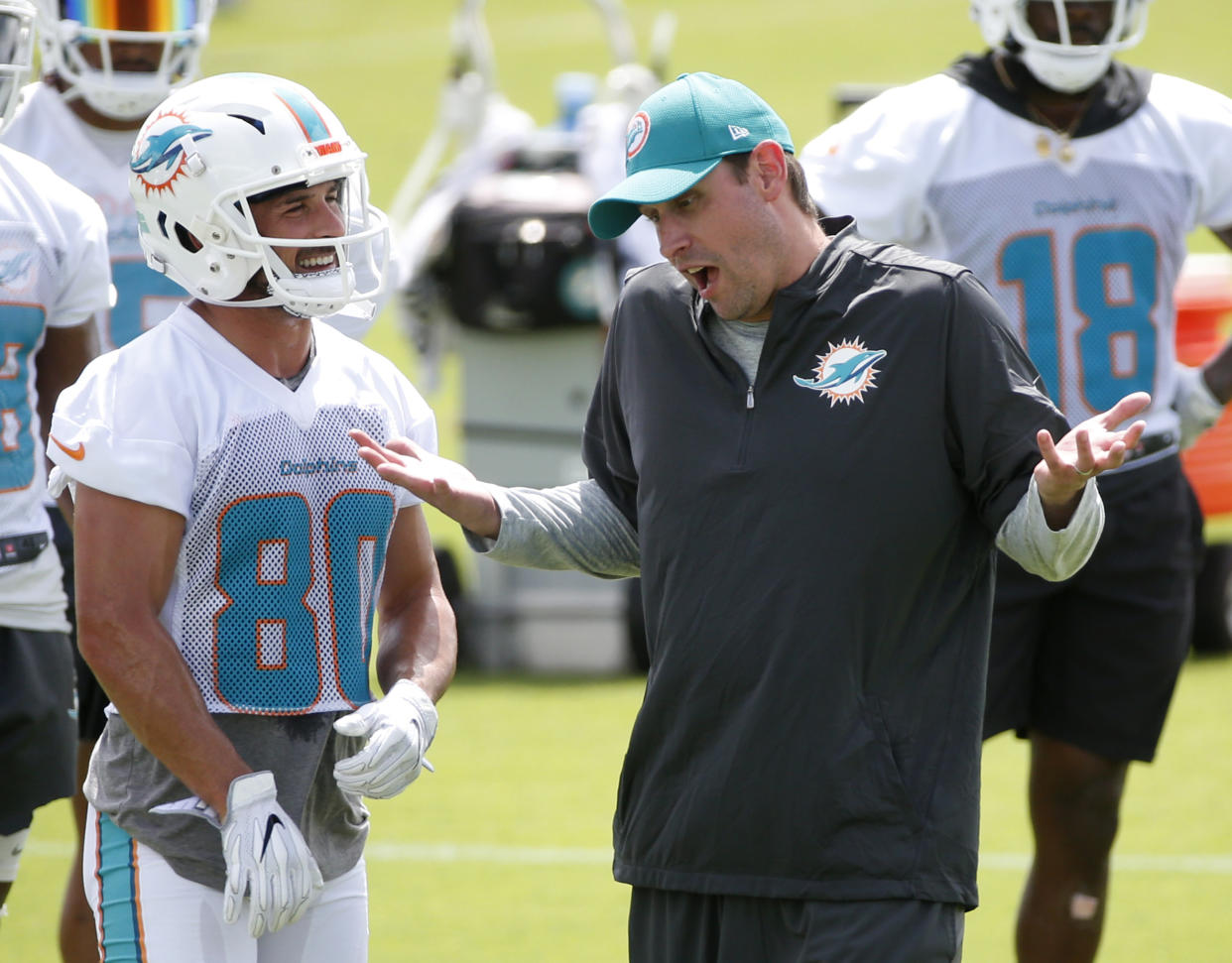 “One of the boys”: Dolphins receiver Danny Amendola, left, describes head coach Adam Gase as the opposite of New England head coach Bill Belichick. (AP)