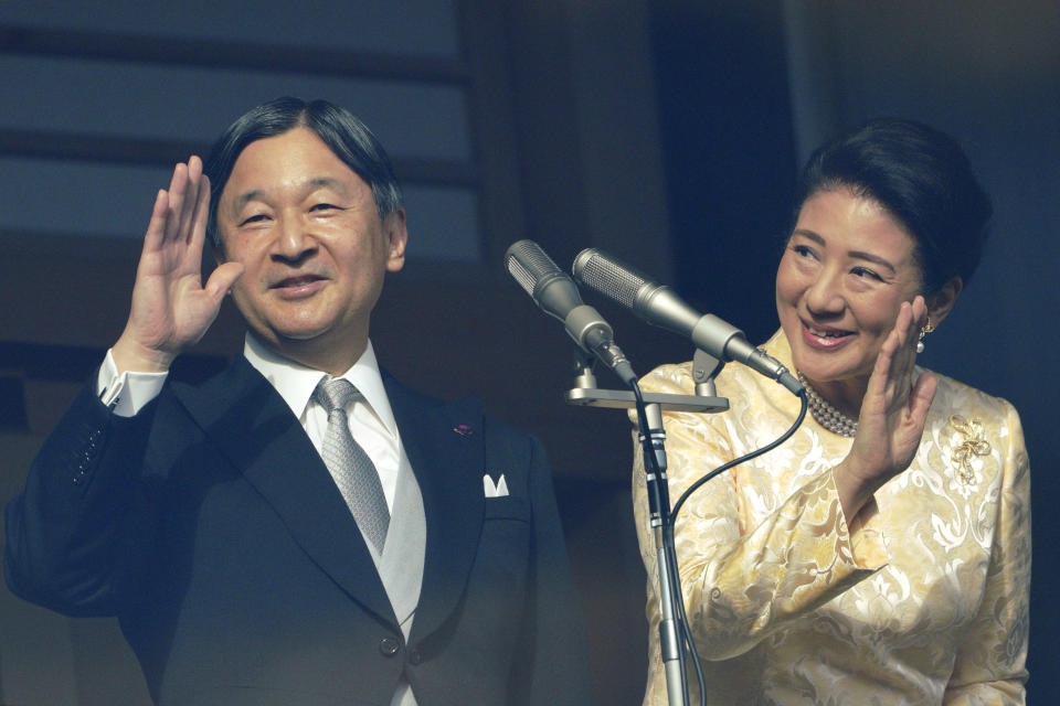 Japan's Emperor Naruhito waves with Empress Masako to well-wishers from the bullet-proofed balcony during a public appearance with his imperial families at Imperial Palace in Tokyo Thursday, Jan. 2, 2020, in Tokyo. (AP Photo/Eugene Hoshiko)