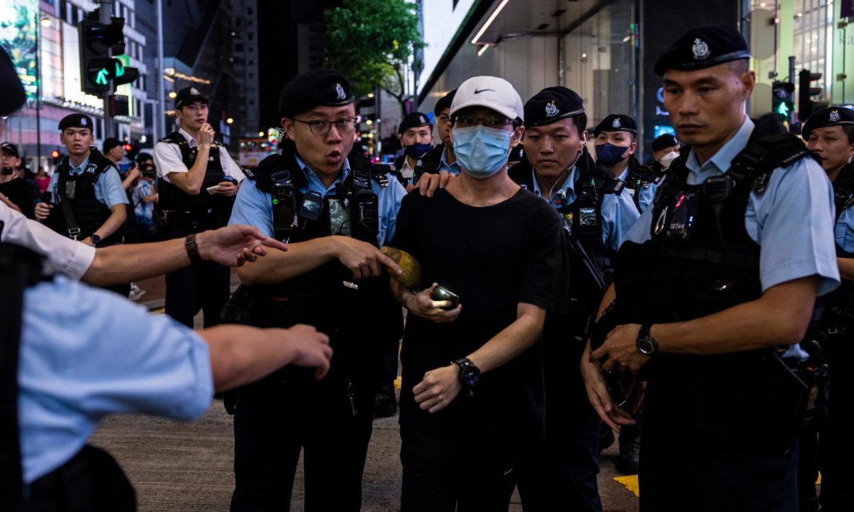 <span>Police lead a man away from a gathering near Victoria Park, Hong Kong’s former venue for the annual Tiananmen vigil, in 2023.</span><span>Photograph: Louise Delmotte/AP</span>