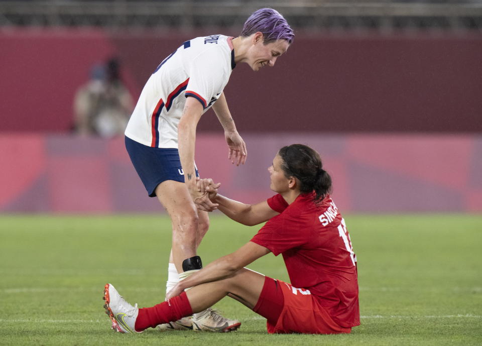 Team United States forward Megan Rapinoe, left, congratulates Team Canada's forward Christine Sinclair (12) after their semifinal soccer match at the Tokyo Olympics in Kashima, Japan, Monday, Aug. 2, 2020. Canada won 1-0. (Frank Gunn/The Canadian Press via AP)