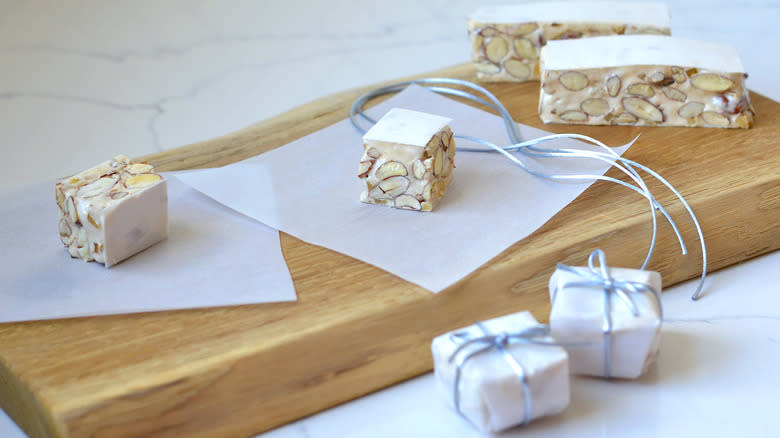 nougat squares on paper on cutting board