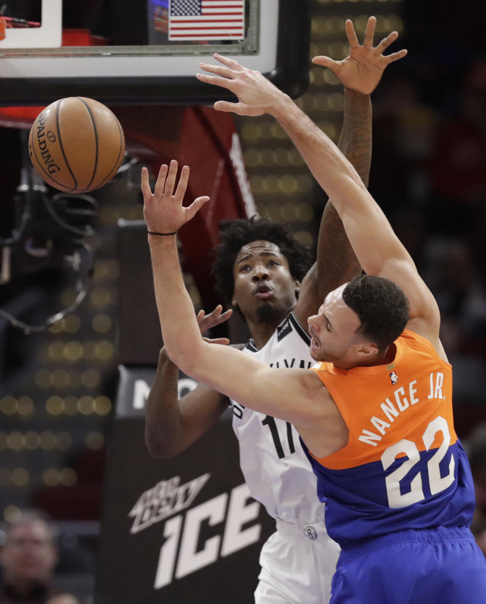 Cleveland Cavaliers' Larry Nance Jr. (22) is stopped by Brooklyn Nets' Ed Davis (17) in the first half of an NBA basketball game, Wednesday, Feb. 13, 2019, in Cleveland. (AP Photo/Tony Dejak)