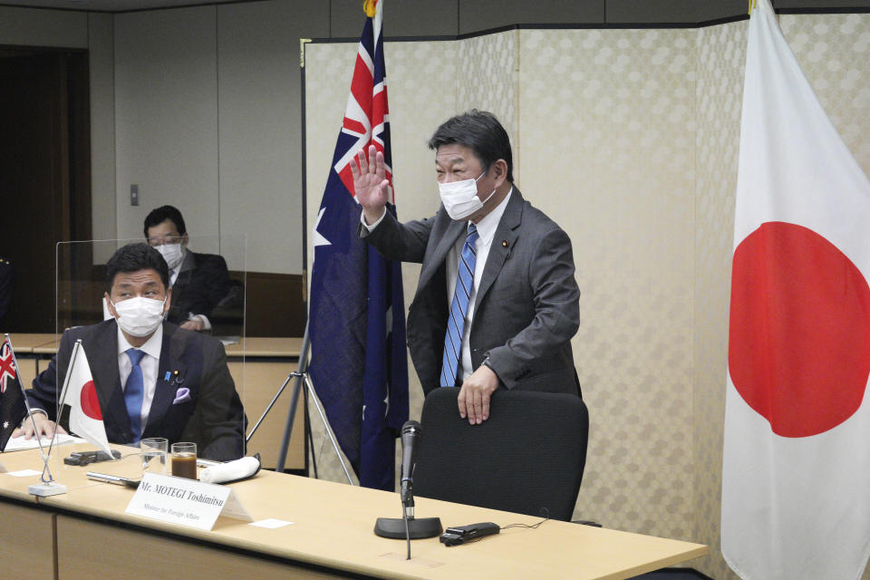 Japanese Foreign Minister Toshimitsu Motegi, right, and Defense Minister Nobuo Kishi, left, attend a video conference with Australian Foreign Minister and Minister for Women Marise Payne and Australian Defense Minister Peter Dutton at Foreign Ministry in Tokyo during their two-plus-two ministerial meeting Wednesday, June 9, 2021, in Tokyo. (AP Photo/Eugene Hoshiko, Pool)