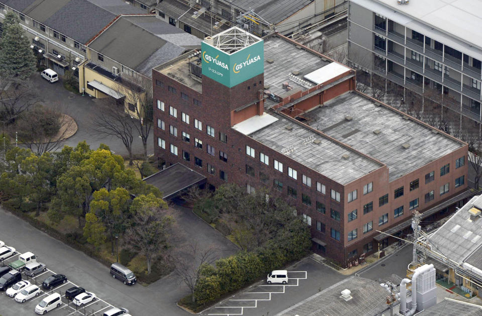 Cars are parked in front of the headquarters of GS Yuasa Corp., the maker of lithium-ion batteries used in Boeing 787 "Dreamliner," in Kyoto, western Japan as Japanese and U.S. investigators conduct a probe of the maker Monday, Jan. 21, 2013. Tsutomu Nishijima, a spokesman for GS Yuasa, said Monday that the investigators visited the company’s headquarters in Kyoto, Japan, and that Yuasa was cooperating with the probe. (AP Photo/Kyodo News) JAPAN OUT, MANDATORY CREDIT, NO LICENSING IN CHINA, HONG KONG, JAPAN, SOUTH KOREA AND FRANCE