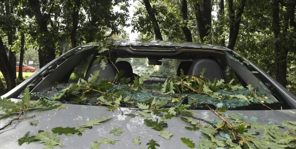 The back window of a car is broken in the Broadmoor area of Colorado Springs, Colo., after a hailstorm with stones the size of baseballs hit the area Monday, Aug. 6, 2018. (Jerilee Bennett/The Gazette via AP)