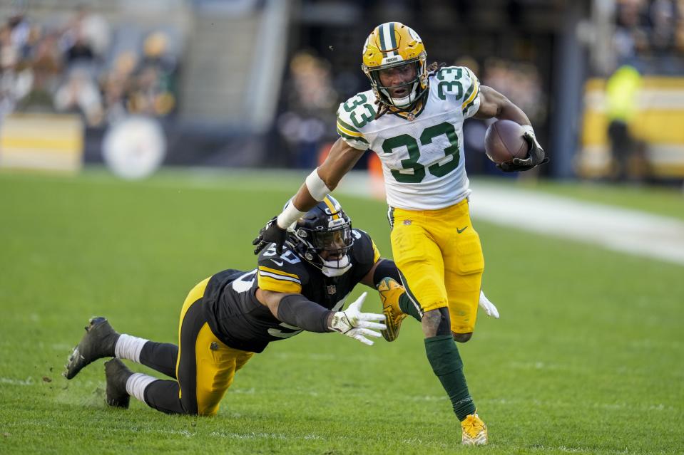 Green Bay Packers' Aaron Jones is stopped by Pittsburgh Steelers' Elandon Roberts during the second half of an NFL football game Sunday, Nov. 12, 2023, in Pittsburgh. (AP Photo/Gene J Puskar)