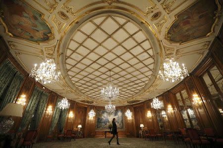 An employee walks through the lobby of the luxury hotel Le Bristol, in Paris, France, July 27, 2015. REUTERS/Stephane Mahe