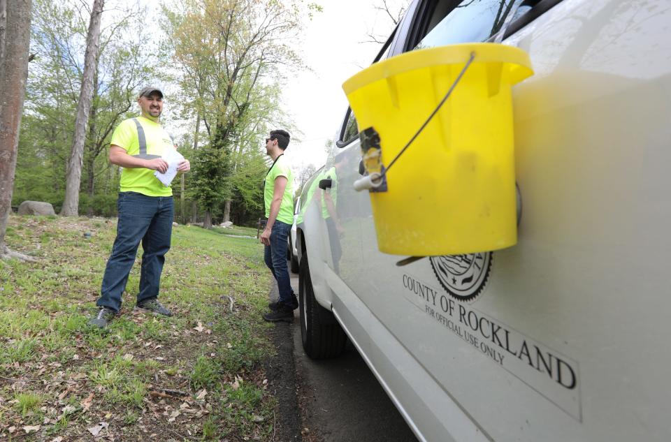 Rockland County environmental health specialists James Hornsbury, left, and Blaise Cassano prepare to treat storm drain for mosquitoes along Galileo Court in Pomona on Wednesday, May 11, 2022.