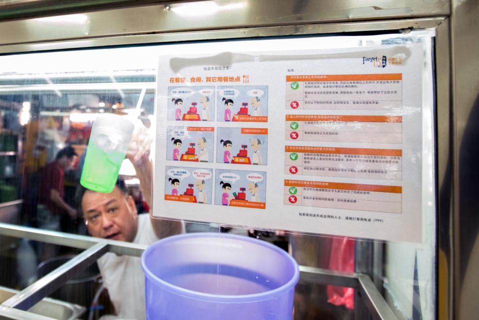 A hawker stall bearing a sign that offers advice on how to deal with patients suffering from dementia. (PHOTO: Stefanus Ian for Yahoo News Singapore)