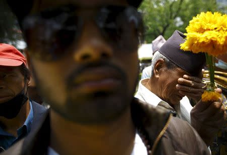 A man (R) cries while paying tribute to the April 25 earthquake victims at Kathmandu May 7, 2015. REUTERS/Navesh Chitrakar