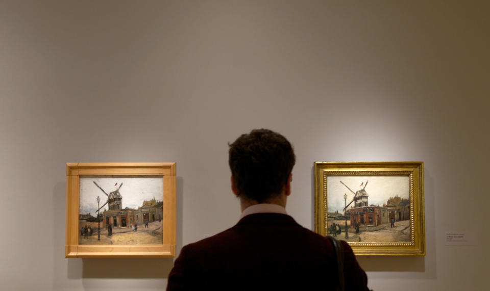 In this Oct. 8, 2013 photo, a visitor looks at Vincent van Gogh's "Le Moulin de la Galette," on display at The Phillips Collection in Washington. In the midst of the shutdown of federally funded museums, the private Phillips Collection is launching the first major exhibition of Vincent van Gogh’s artwork in Washington in 15 years. (AP Photo/Molly Riley)