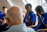 CORRECTS SPELLING OF NAME TO SHAUL PAUL LADANY INSTEAD OF SHAUL PAUL LADY - Holocaust survivor Shaul Paul Ladany talks to youth players of FC Chelsea in Nuremberg, Germany, Friday, July 29, 2022. Some of Europe's best young soccer players from the under-17 teams of Chelsea, Bayern Munich, Bologna and other international clubs contest the Walther Bensemann Memorial Tournament in Nuremberg, where they also learn the dangers of intolerance by meeting Holocaust survivors, attending workshops and taking part in excursions. (AP Photo/Michael Probst)