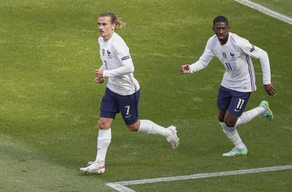 France's Antoine Griezmann, left, reacts after scoring his team's first goal during the Euro 2020 soccer championship group F match between Hungary and France at the Ferenc Puskas stadium in Budapest, Hungary, Saturday, June 19, 2021. (AP Photo/Laszlo Balogh,Pool)