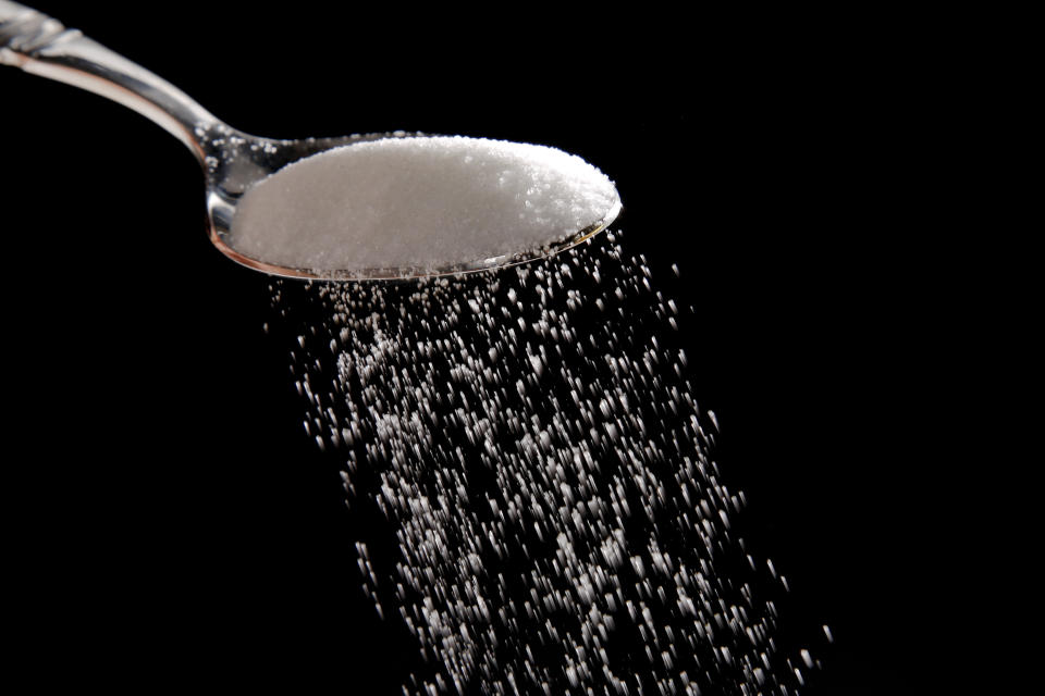 FILE - Granulated sugar is poured in Philadelphia, Sept. 12, 2016. A federal judge has rejected the Justice Department's bid to block a major U.S. sugar manufacturer from acquiring its rival, clearing the way for the acquisition to proceed. The ruling, handed down Friday, Sept. 23, 2022, by a federal judge in Wilmington, Del., comes months after the Justice Department sued to try to halt the deal between U.S. Sugar and Imperial Sugar Company, one of the largest sugar refiners in the nation. (AP Photo/Matt Rourke, File)