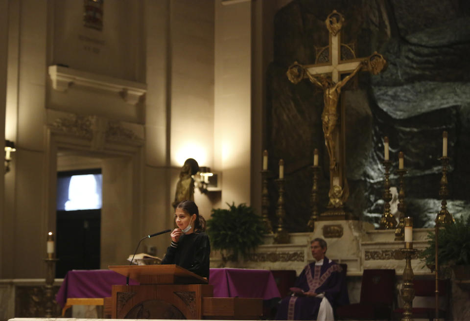 A young French parishioner speaks during Mass at the Church of Notre Dame in New York, on Sunday, March 6, 2022. (AP Photo/Jessie Wardarski)