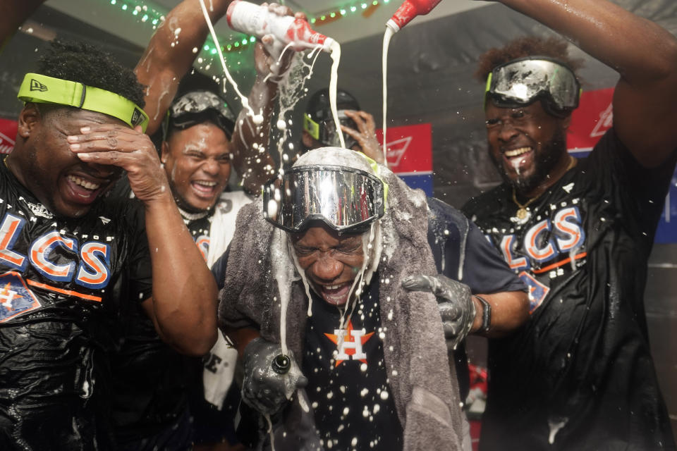 Houston Astros manager Dusty Baker Jr., center, celebrates with pitcher Hector Neris, left, and pitcher Cristian Javier, right, after defeating the Seattle Mariners in Game 3 of an American League Division Series baseball game Saturday, Oct. 15, 2022, in Seattle. (AP Photo/Abbie Parr)