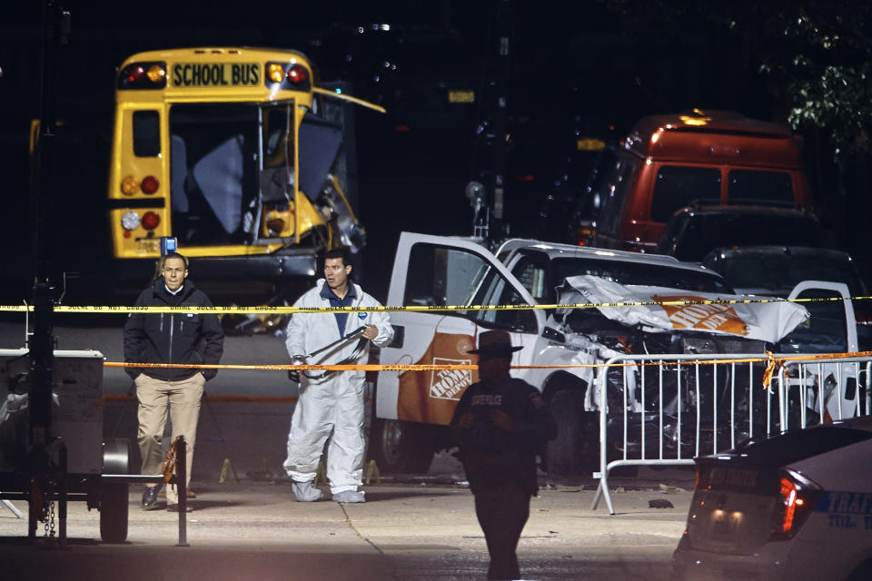 <p>Police work near a damaged Home Depot truck after a motorist drove onto a bike path near the World Trade Center memorial, striking and killing several people, Wednesday, Nov. 1, 2017, in New York. (Photo: Andres Kudacki/AP) </p>