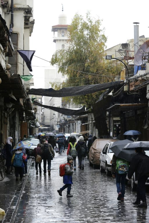 Syrian students head to school on February 18, 2018, after a few days of calm in Damascus's Old City, often targeted by rebels in an enclave on the edge of the capital