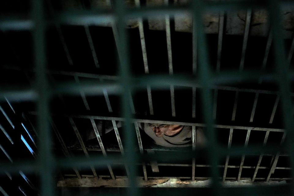 A drug addict undergoing treatment looks out from behind the iron bars of the detoxification ward of a drug treatment camp in Kabul, Afghanistan, Monday, May 30, 2022. Drug addiction has long been a problem in Afghanistan, the world’s biggest producer of opium and heroin. The ranks of the addicted have been fueled by persistent poverty and by decades of war that left few families unscarred. (AP Photo/Ebrahim Noroozi)