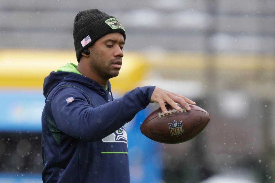 Seattle Seahawks’ Russell Wilson warms up before an NFL football game against the Green Bay Packers Sunday, Nov. 14, 2021, in Green Bay, Wis. (AP Photo/Matt Ludtke)