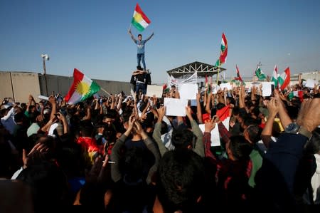 Syrian Kurds protest the Turkish offensive against Syria during a demonstration in front of the United Nation Headquarter in Erbil