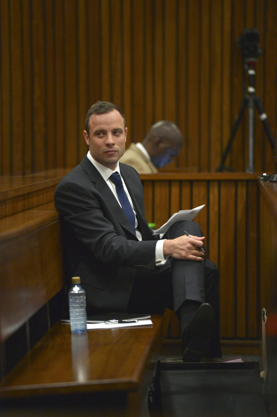 Oscar Pistorius sits in the dock as he listens to cross questioning about the events surrounding the shooting death of his girlfriend Reeva Steenkamp in court during the second week of his trial in Pretoria, South Africa, Wednesday, March 12, 2014. Pistorius is charged with the shooting death of Steenkamp, on Valentine's Day in 2013. (AP Photo/Alexander Joe, Pool)