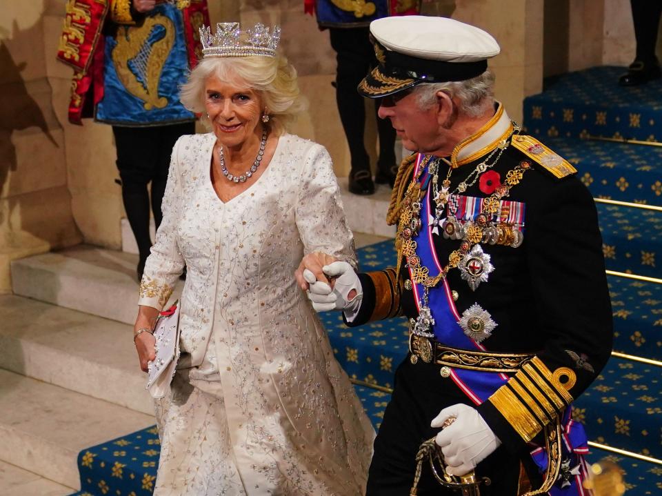 King Charles III and Queen Camilla hold hands following the State Opening of Parliament in London on Nov. 7, 2023.
