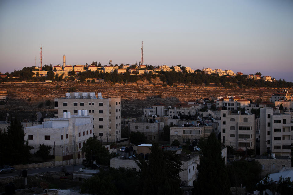 Part of the Israeli settlement of Psagot, top, overlooks Palestinian the West Bank city of Al-Bireh, Tuesday, Nov. 17, 2020. Secretary of State Mike Pompeo's expected tour of a West Bank winery this week will be the first time a top U.S. diplomat has visited an Israeli settlement, a parting gift from an administration that has taken unprecedented steps to support Israel's claims to war-won territory. (AP Photo/Majdi Mohammed)
