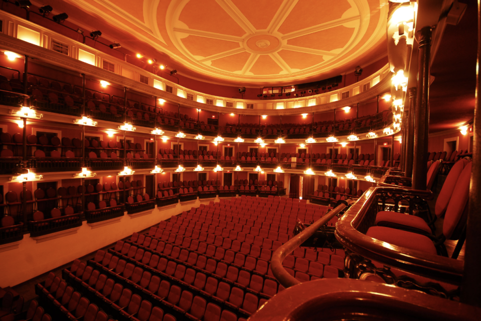 a large theater with red seats