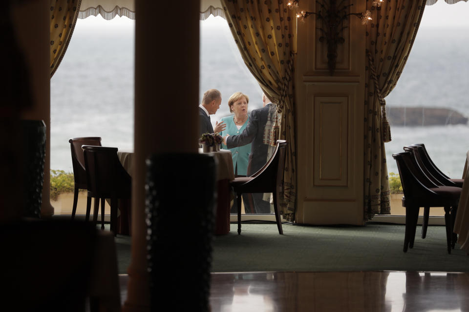 German Chancellor Angela Merkel, center, talks to President of the European Council Donald Tusk, left, and British Prime Minister Boris Johnson during a G7 coordination meeting with the Group of Seven European members at the Hotel du Palais in Biarritz, southwestern France, Saturday, Aug. 24, 2019. Efforts to salvage consensus among the G-7 rich democracies frayed Saturday in the face of U.S. President Donald Trump's unpredictable America-first approach even before the official start of the summit in southern France. (AP Photo/Markus Schreiber, Pool)