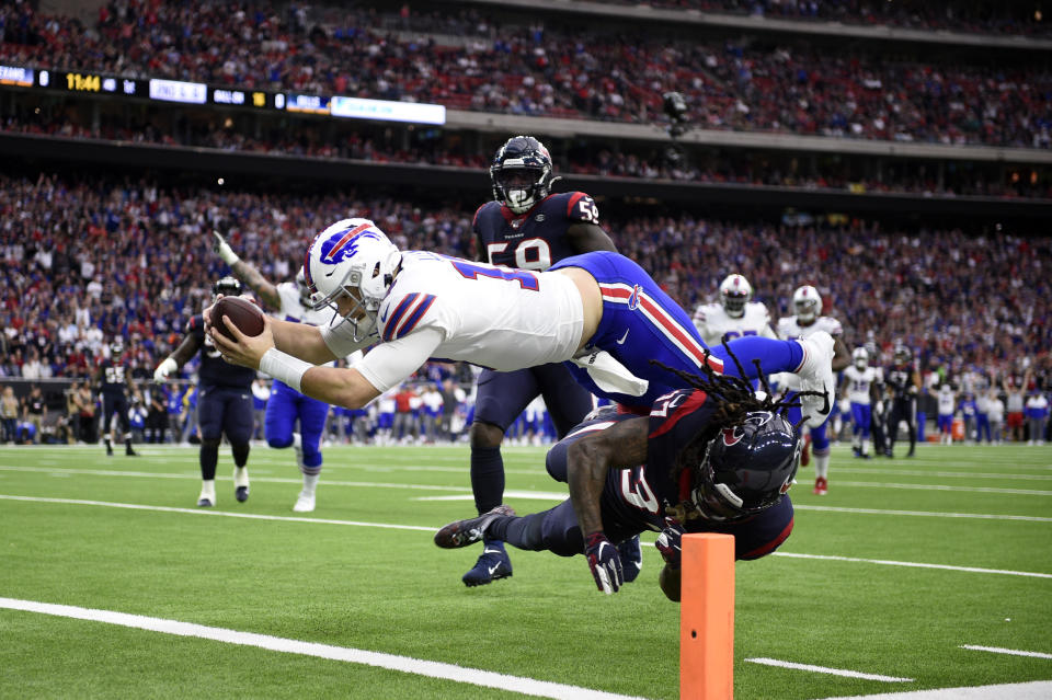 Buffalo Bills quarterback Josh Allen (17) dives to score a touchdown after catching a pass as Houston Texans strong safety Jahleel Addae (37) defends during the first half of an NFL wild-card playoff football game Saturday, Jan. 4, 2020, in Houston. (AP Photo/Eric Christian Smith)