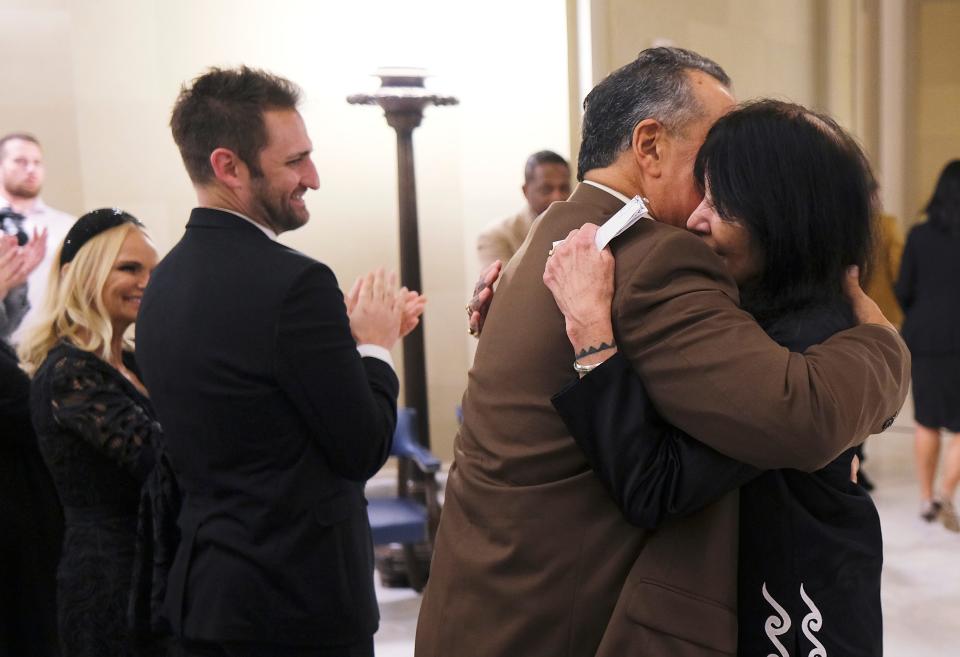 Oklahoma Cultural Treasure Joy Harjo hugs her husband, Owen Sapulpa, as Oklahoma Cultural Ambassador Kristin Chenoweth and her fiance, Josh Bryant, applaud at the Governor's Arts Awards for Excellence in the Arts at the Capitol, Tuesday, November 9, 2021.