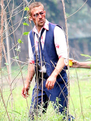 Ryan Gosling looks a little roughed up and really hot on the set