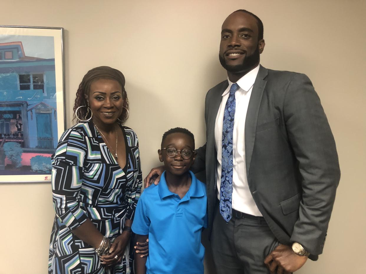 Canton boy previously charged with aggravated assault smiles next to his mother, Cameishi Lindley and his defense attorney, Maurice Davis. (Photo: Maurice Davis)