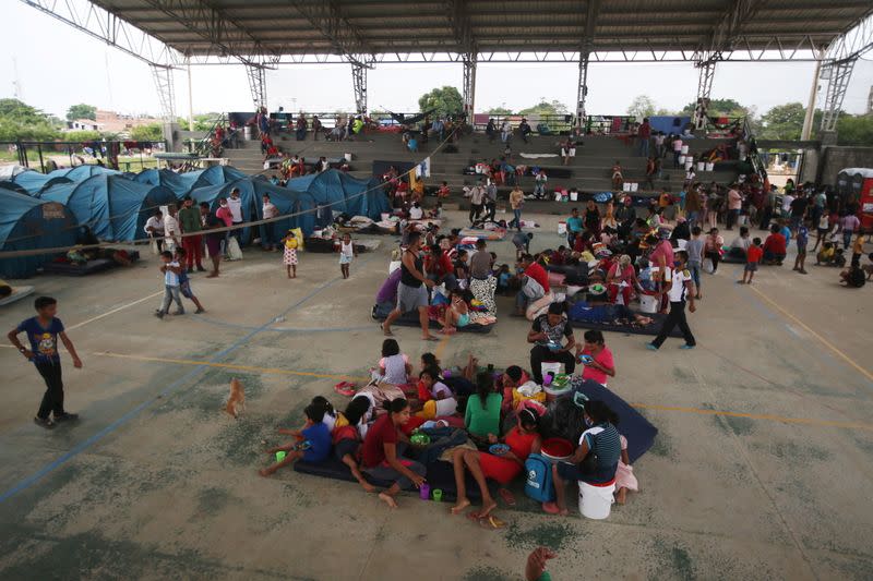 Venezuelan migrants are seen inside a coliseum where a temporary camp has been set up, after fleeing their country due to military operations, according to the Colombian migration agency, in Arauquita